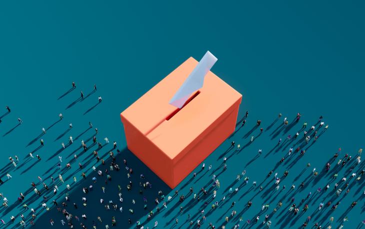 orange ballot box against a green background 