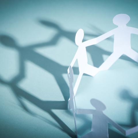 paper chain on people against a blue background 